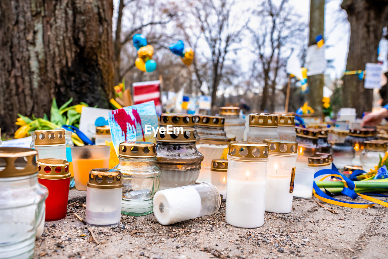 Thousands candles and flowers standing on the street during the war in ukraine