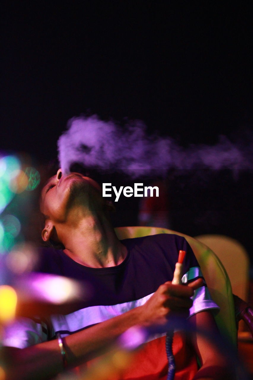 Man exhaling smoke