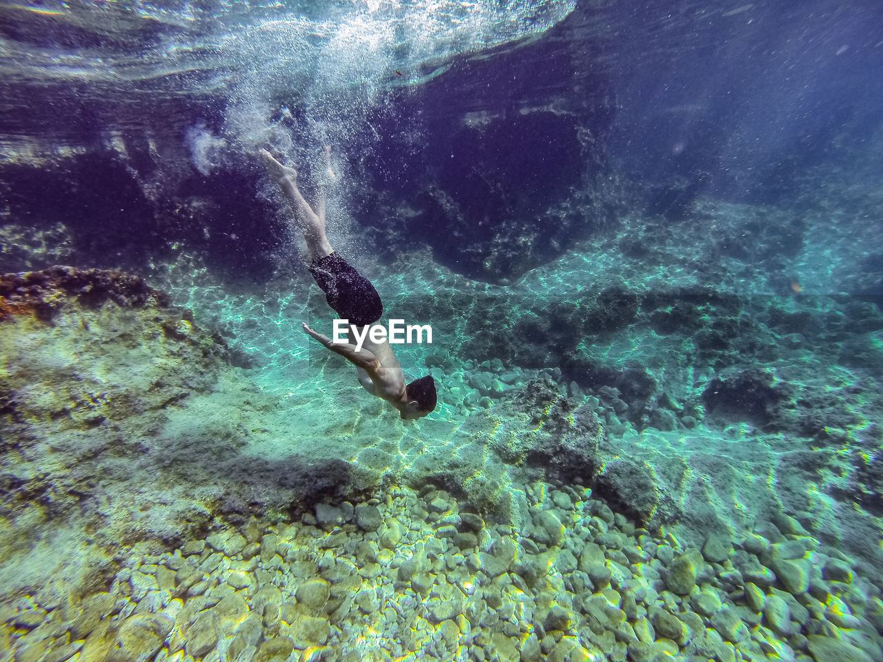 YOUNG MAN SWIMMING IN SEA