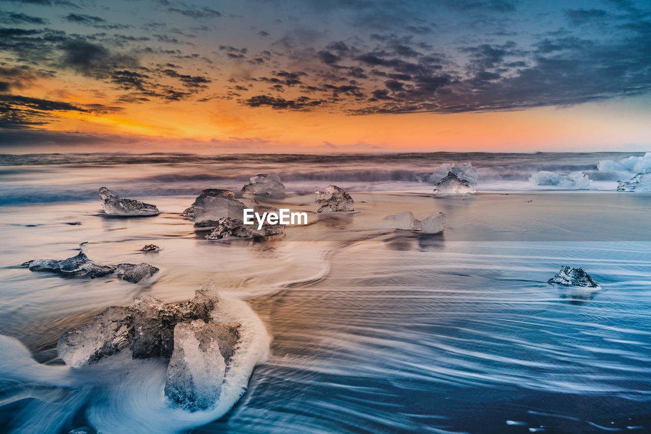 Scenic view of sea against sky during sunset