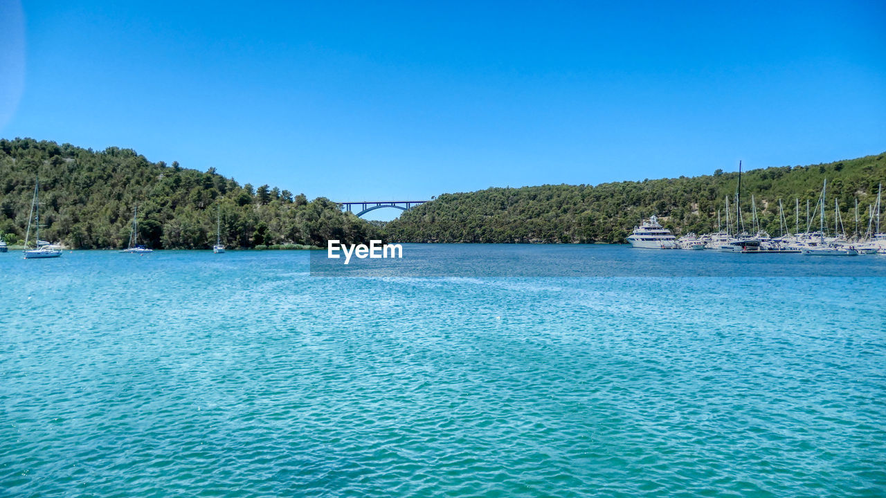 Scenic view of skradin lake against clear blue sky