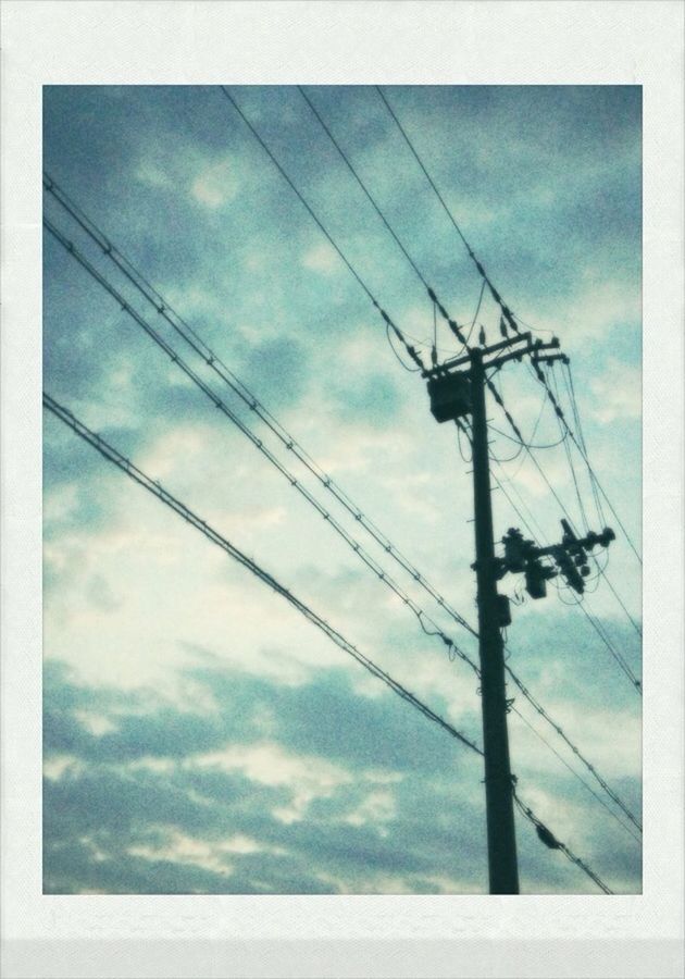 LOW ANGLE VIEW OF POWER LINES AGAINST CLOUDY SKY