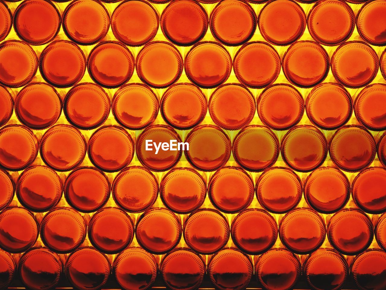 Full frame shot of glass bottles stacked