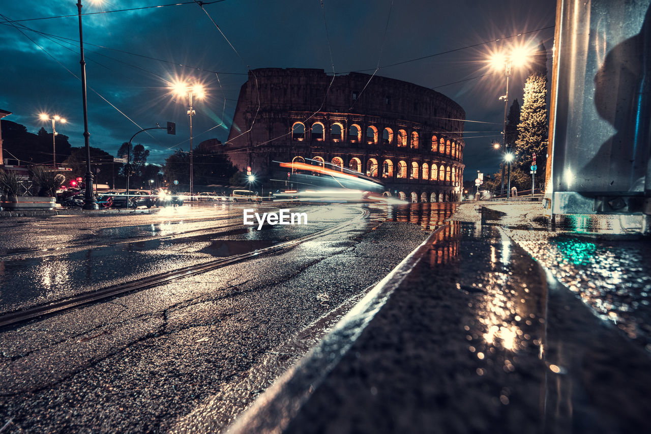 Traffic in colosseum at night. rome, italy