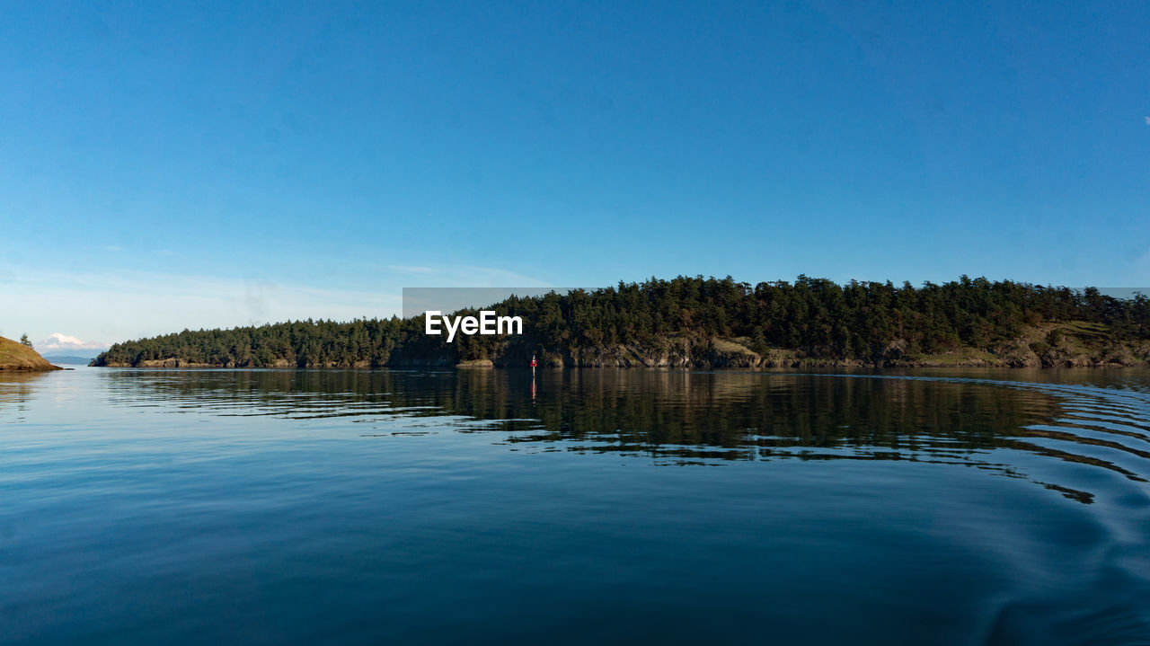 PANORAMIC VIEW OF LAKE AGAINST BLUE SKY