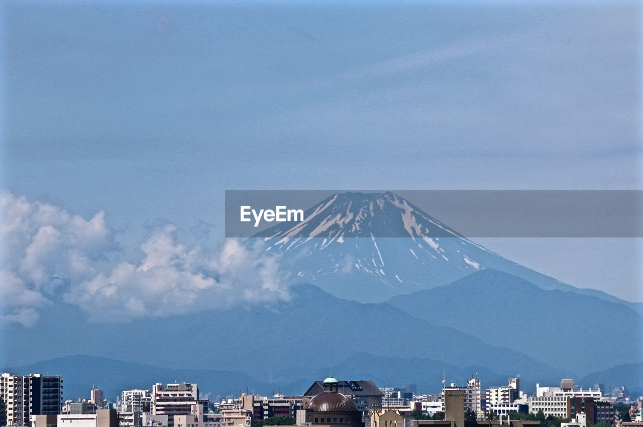 Scenic view of cityscape against mount fuji