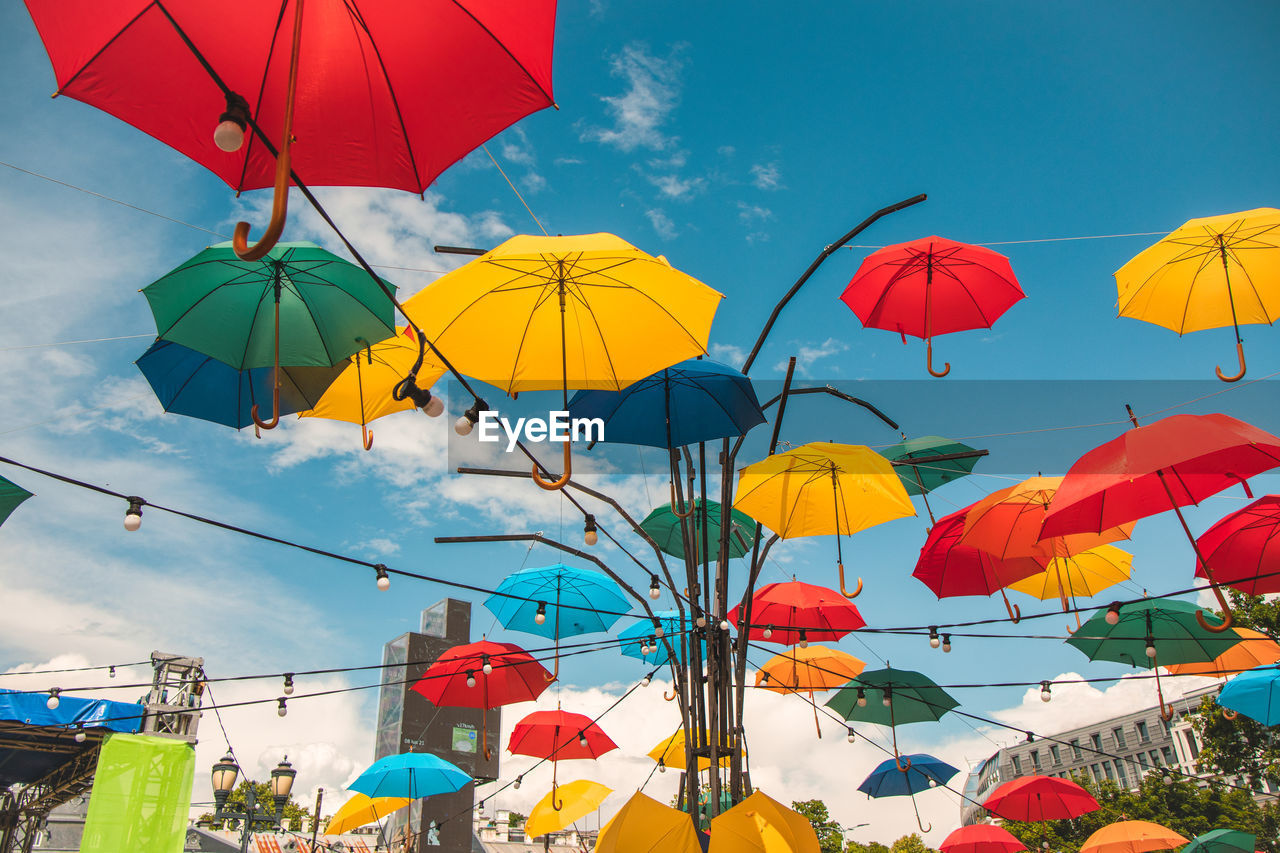 LOW ANGLE VIEW OF UMBRELLAS AGAINST SKY