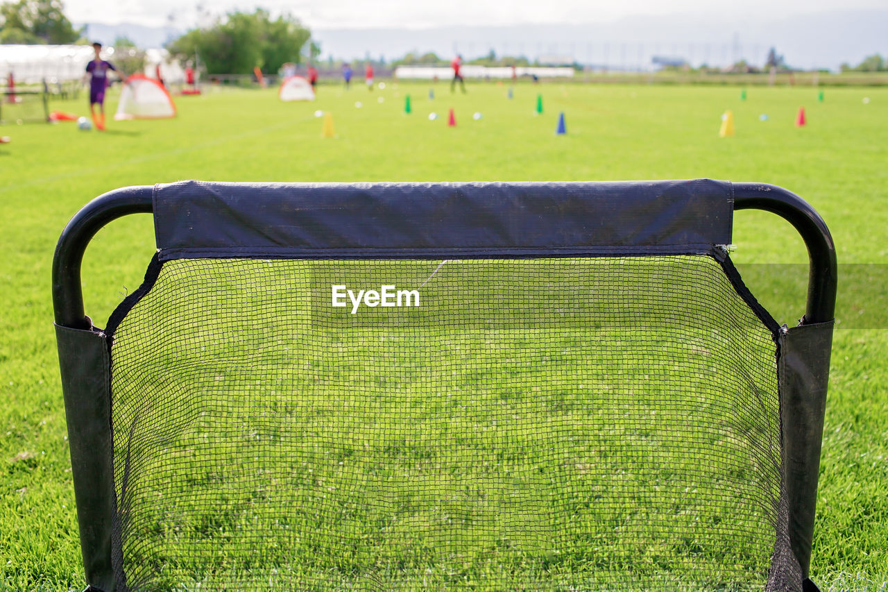 Soccer gears on green grass prepared for training in kids football academy. popular sport activity