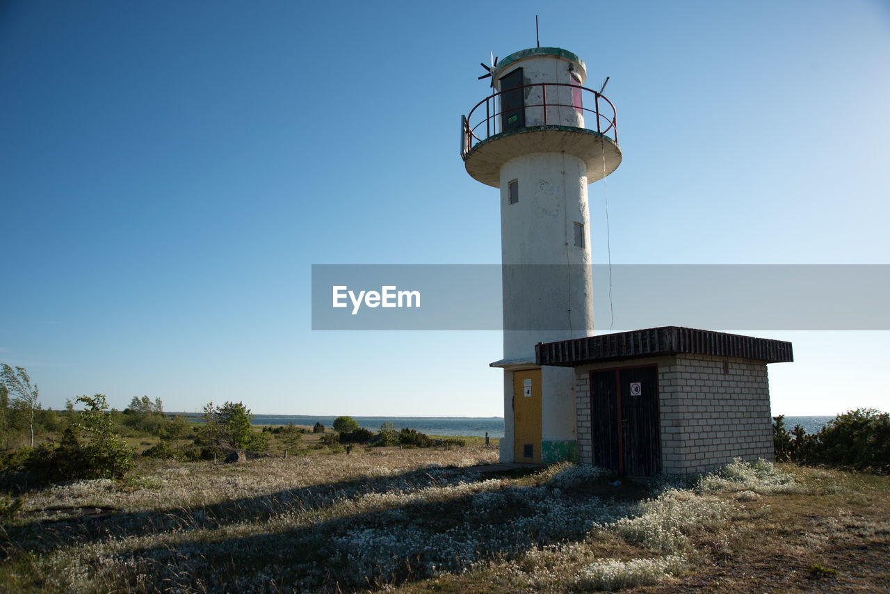 Lighthouse against clear blue sky