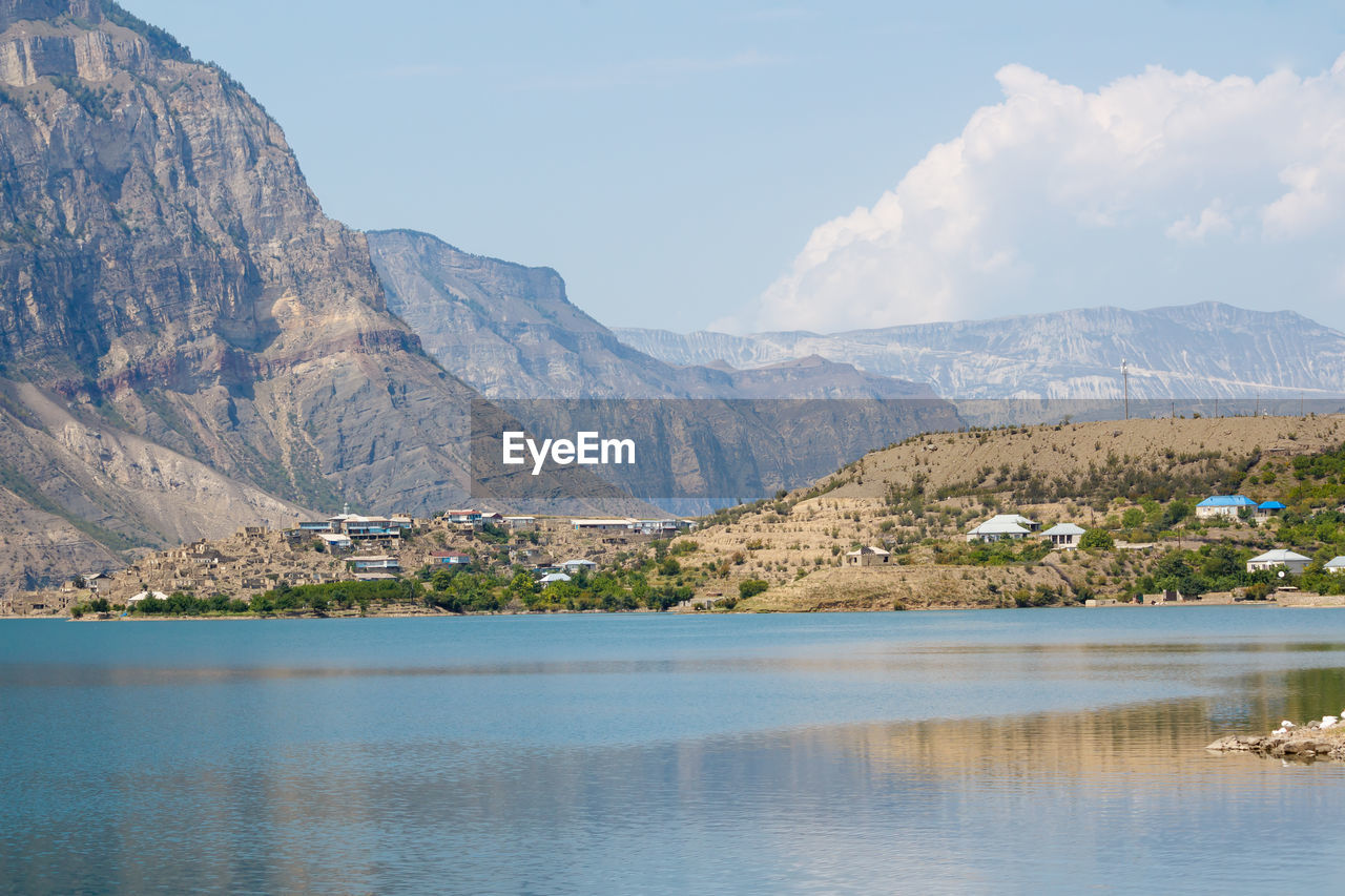 Scenic view of lake and mountains against sky