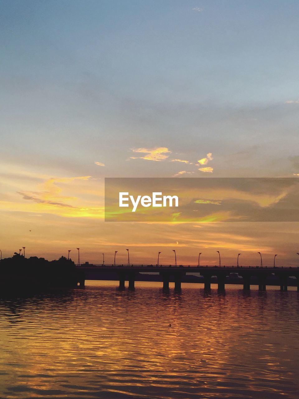 Scenic view of river against sky during sunset