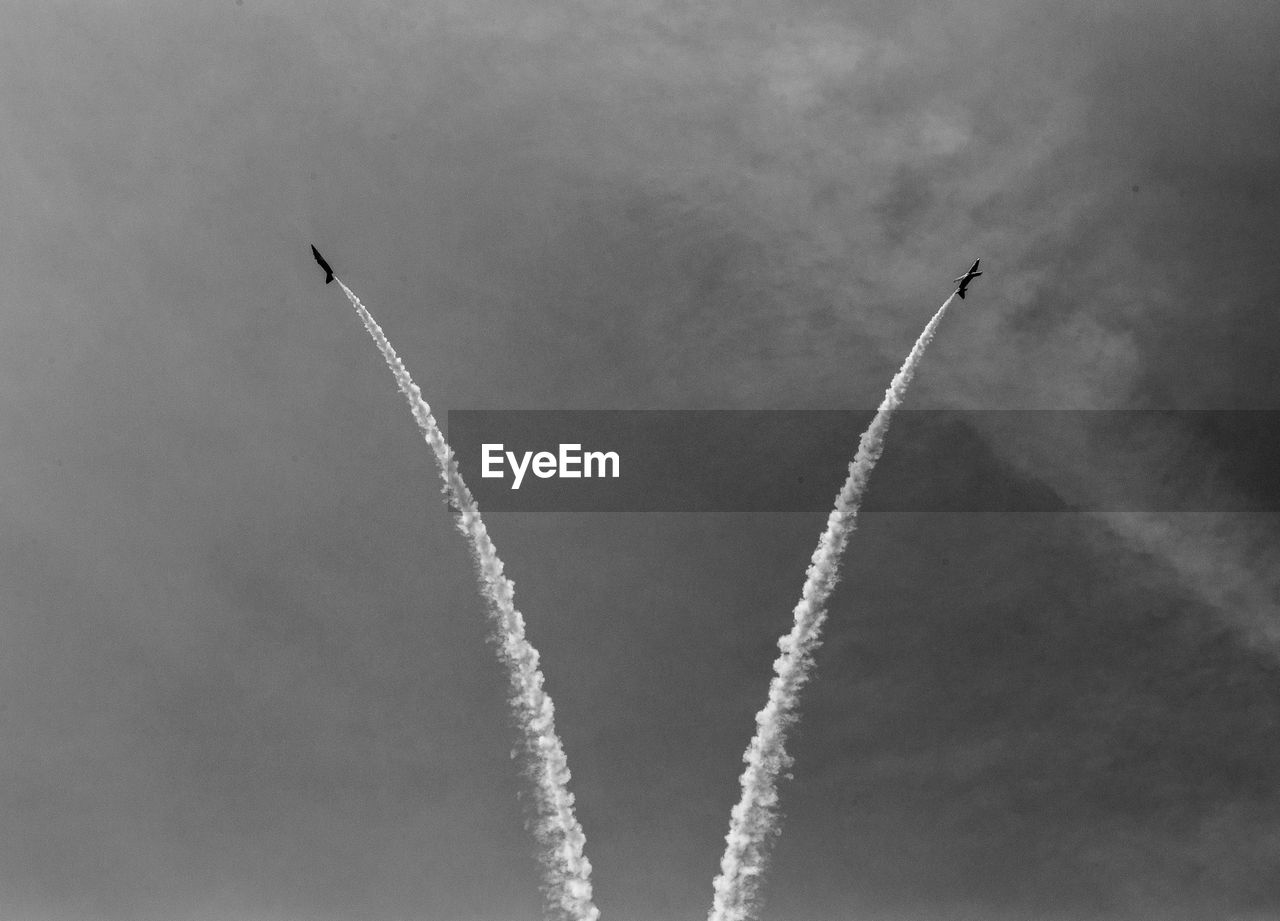 Low angle view of airplane flying against sky