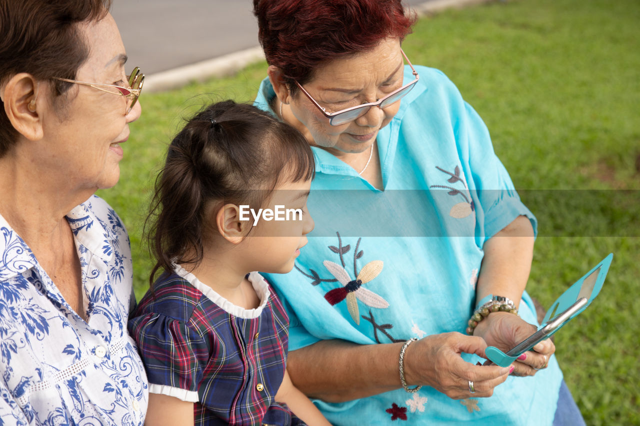 Family using smartphone outdoors