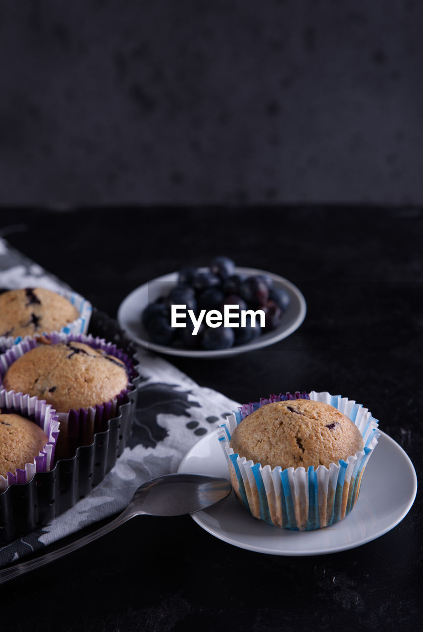 Delicious homemade cupcakes filled with blueberries and presented in small molds.