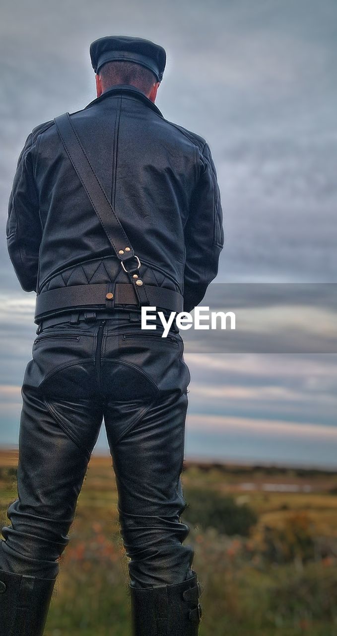 one person, rear view, men, standing, sky, adult, clothing, nature, cloud, day, outdoors, land, landscape, hat, three quarter length, protection, focus on foreground, occupation