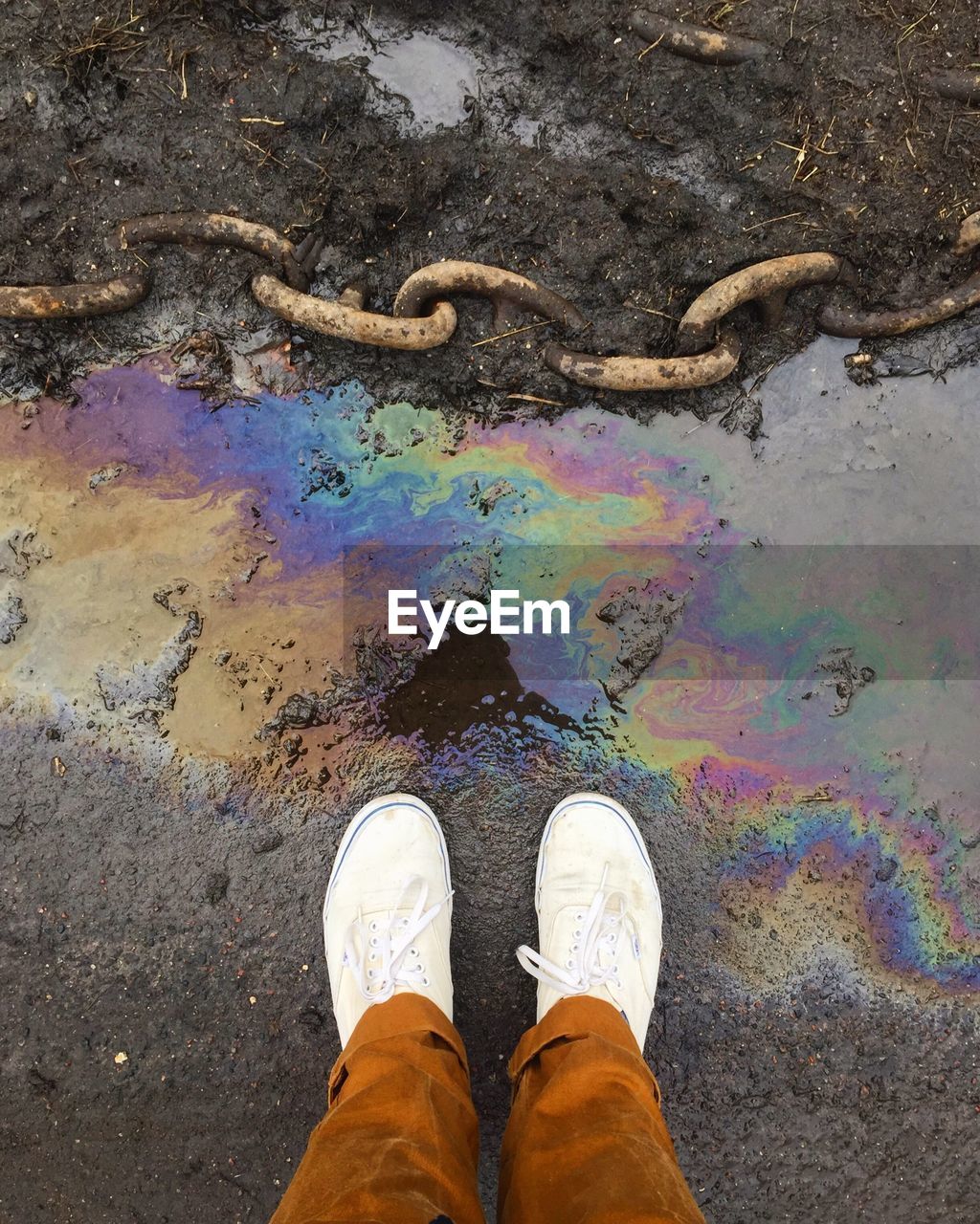 Low section of man standing by puddle