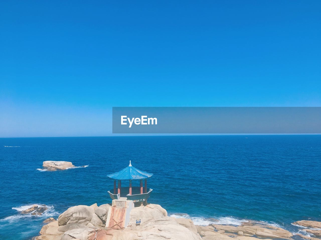 Scenic view of sea against clear blue sky