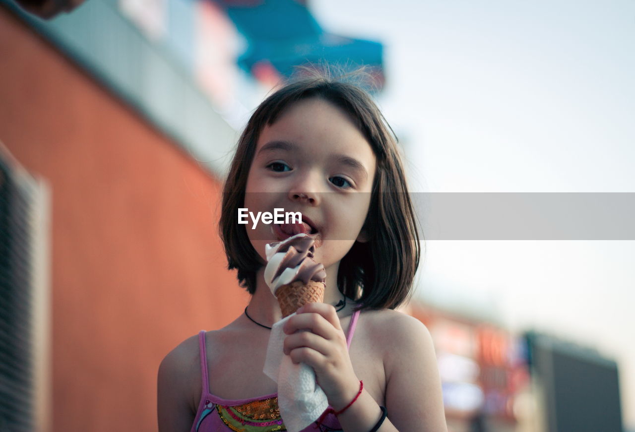Little girl eating ice cream outdoors