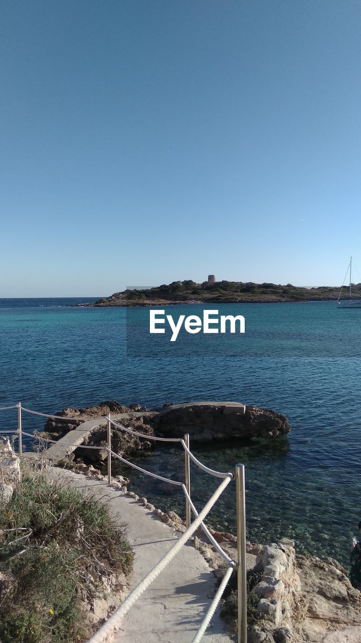 Scenic view of sea against clear blue sky