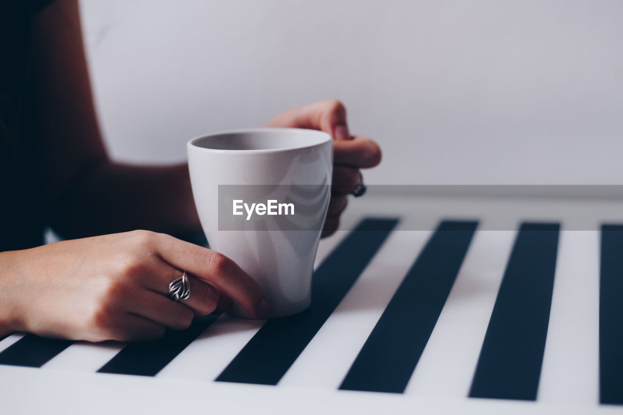 Close-up of hand holding coffee cup