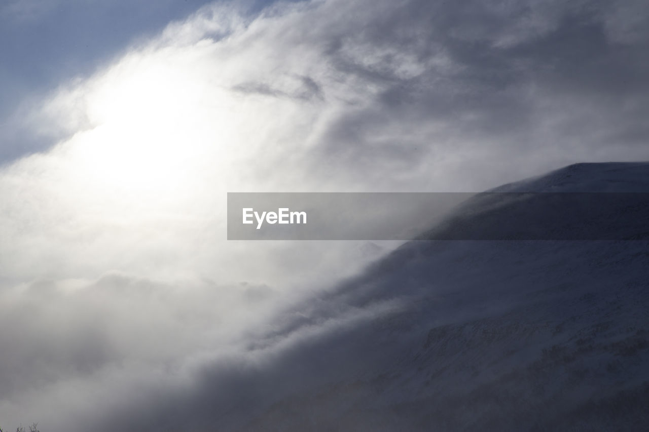 sky, cloud, environment, beauty in nature, nature, scenics - nature, mountain, cloudscape, no people, landscape, dramatic sky, outdoors, storm, overcast, sunlight, tranquility, horizon, day, fog, awe, sunbeam, mountain range, idyllic, tranquil scene, storm cloud