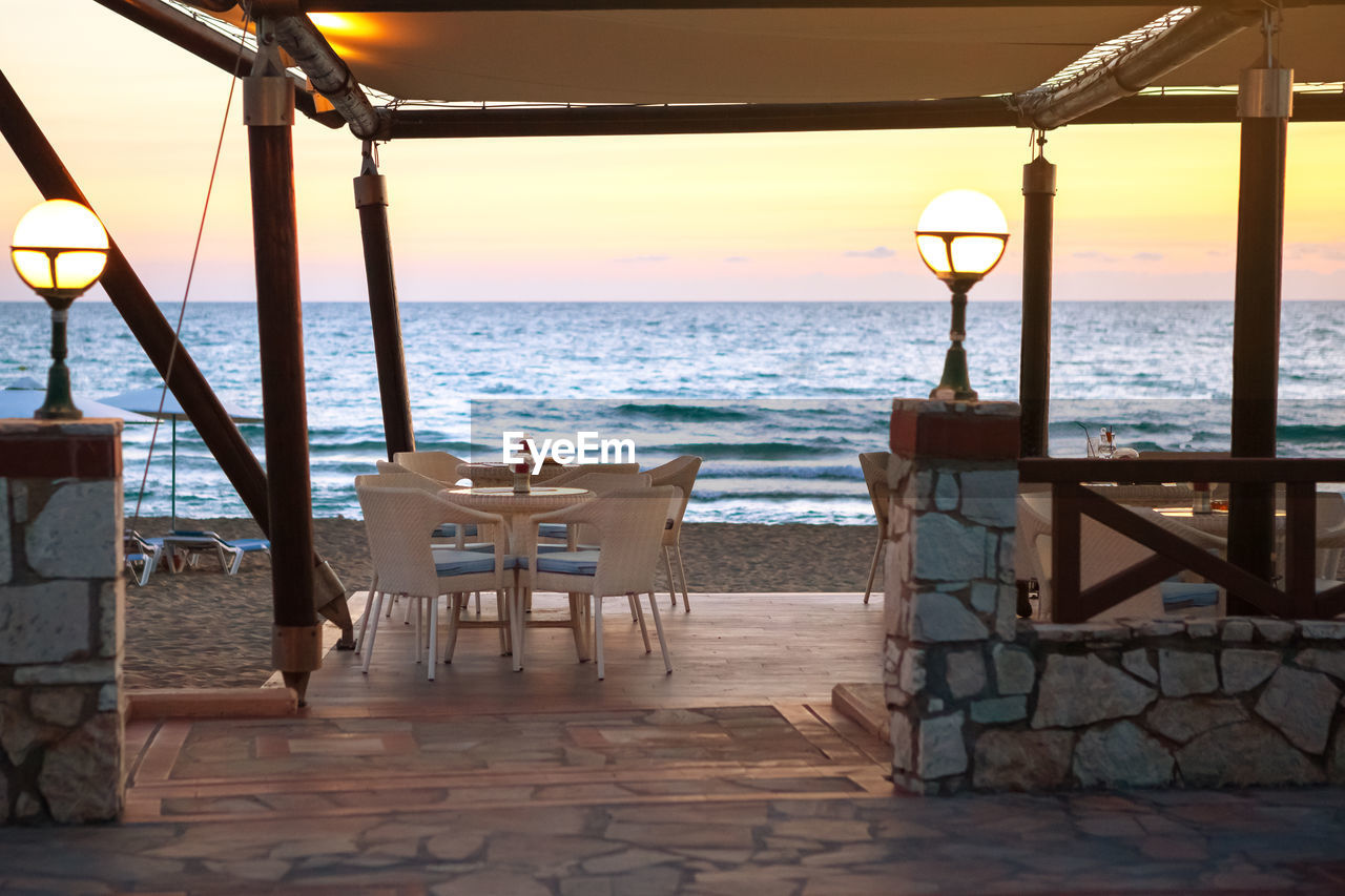 Entrance to empty cafe on sandy beach at sunset. concept of travel and vacation. velvet season