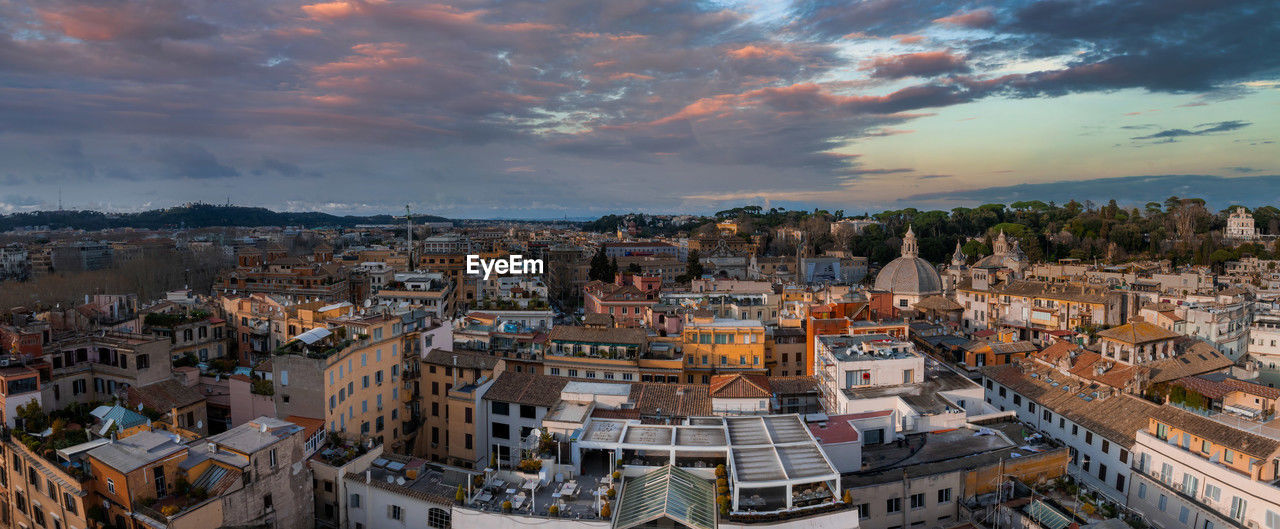high angle view of buildings in city against sky during sunset