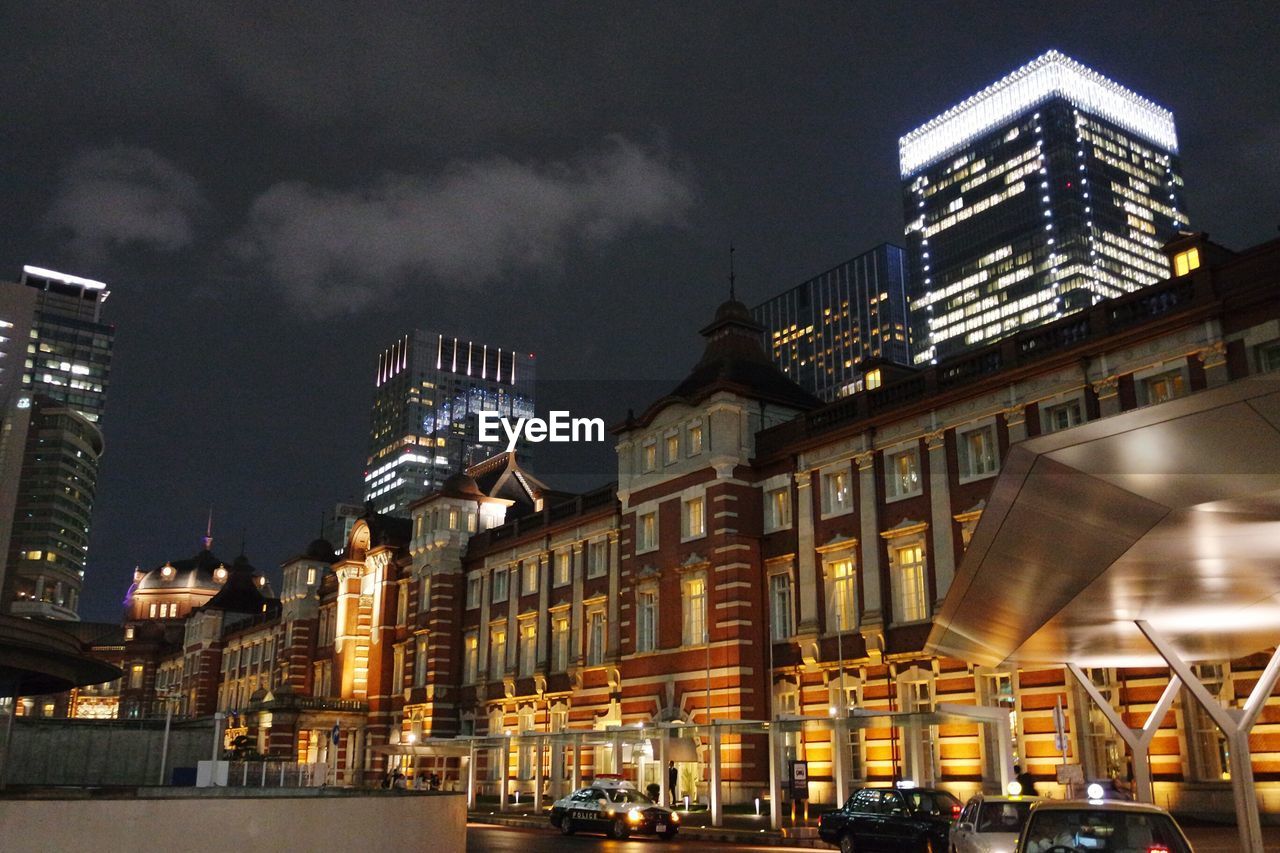 ILLUMINATED BUILDINGS IN CITY AT NIGHT