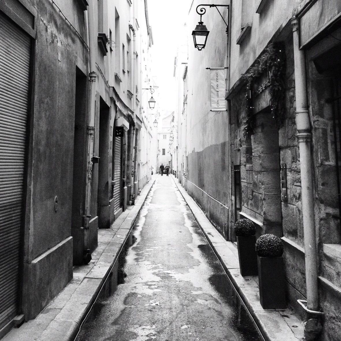 NARROW ALLEY WITH BUILDINGS IN BACKGROUND