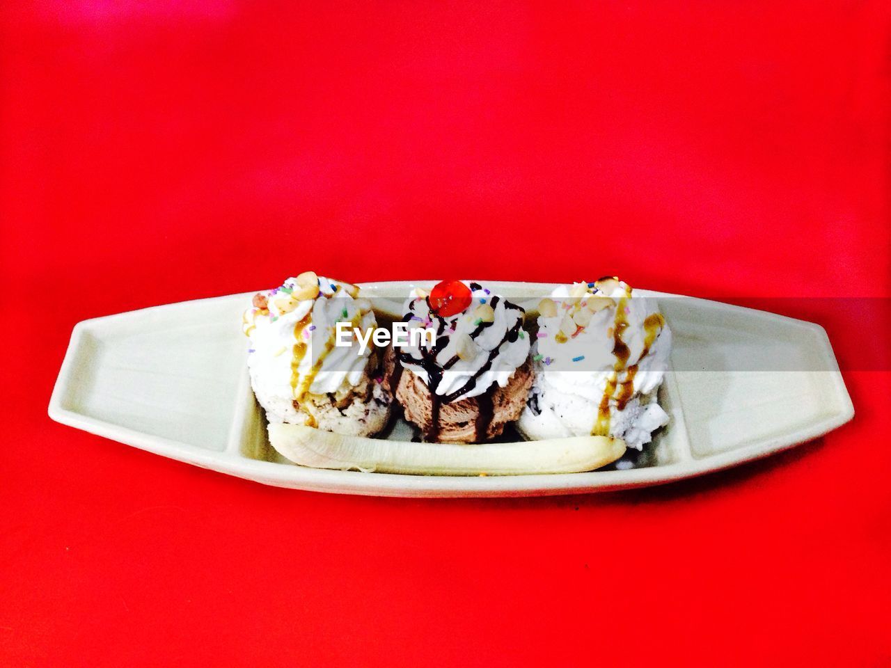 High angle view of dessert served in plate on red background