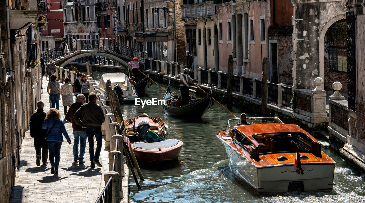 PEOPLE IN BOAT AT CANAL