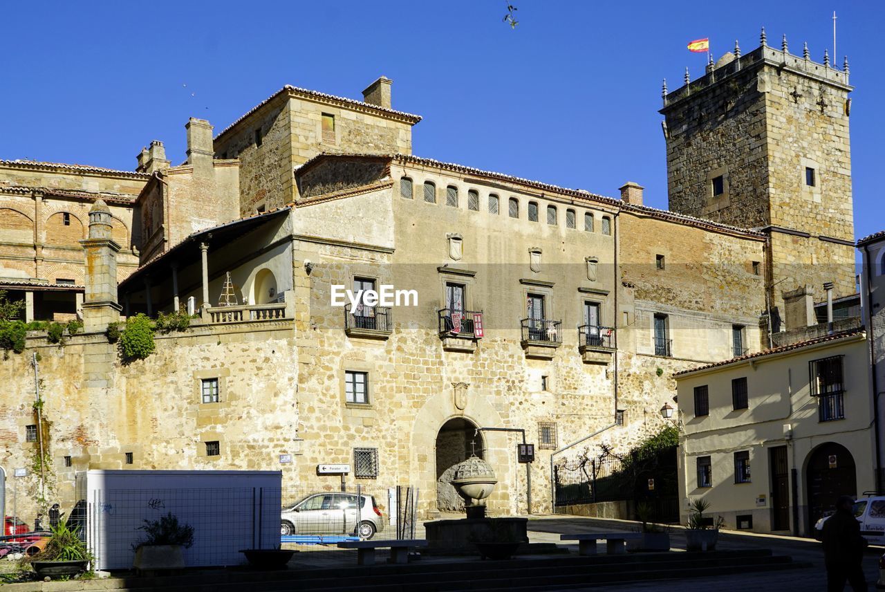 Low angle view of old building against clear blue sky. palacio marques de mirabel. plasencia. 