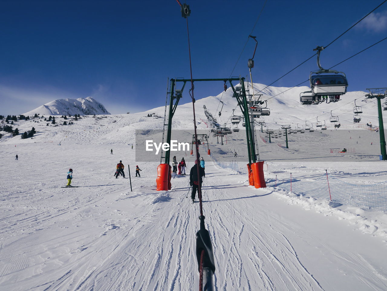 People skiing on snow covered field