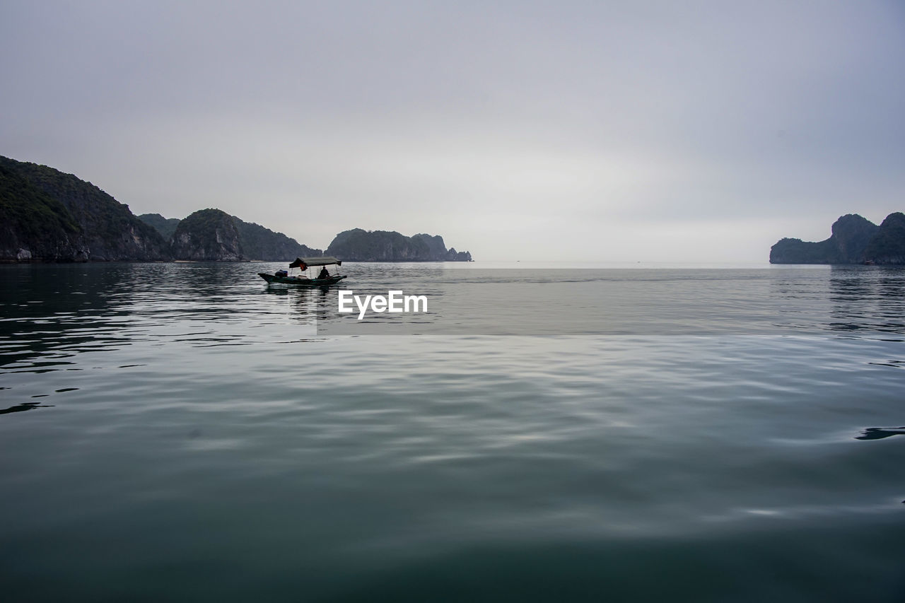 Scenic view of rocks in sea against sky