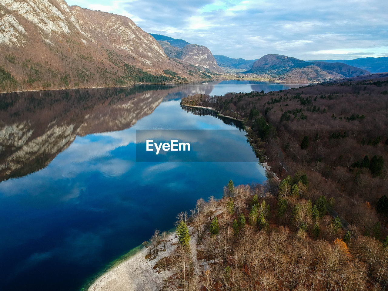 Scenic view of lake and mountains against blue sky