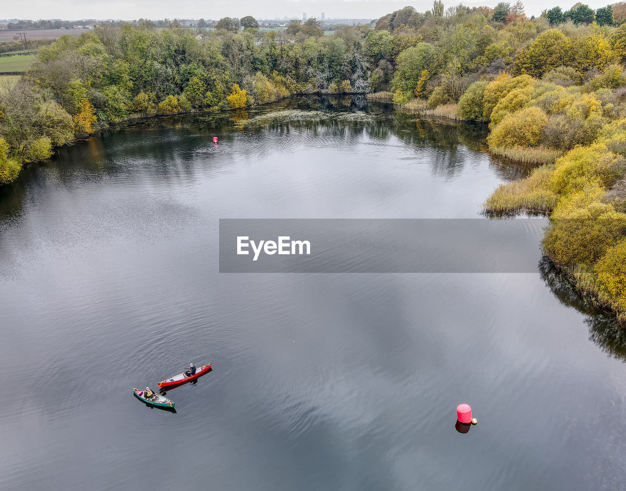 HIGH ANGLE VIEW OF PEOPLE BY LAKE