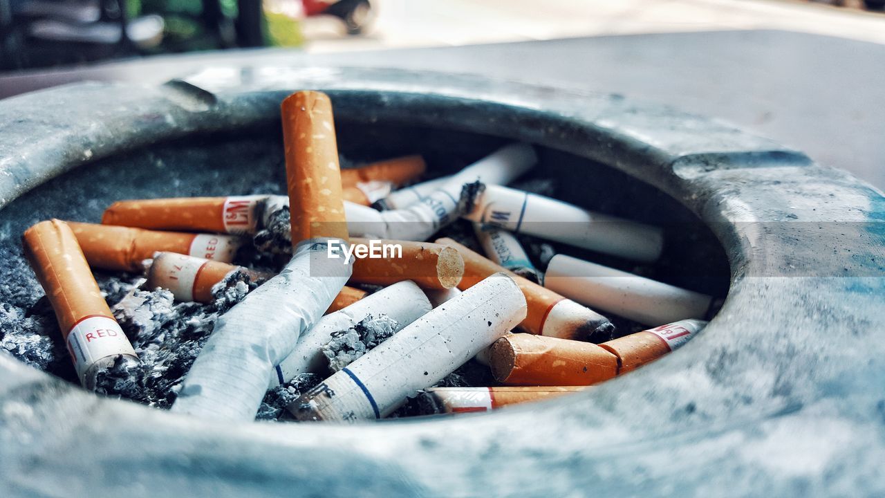 CLOSE-UP OF CIGARETTE SMOKING ON FLOOR