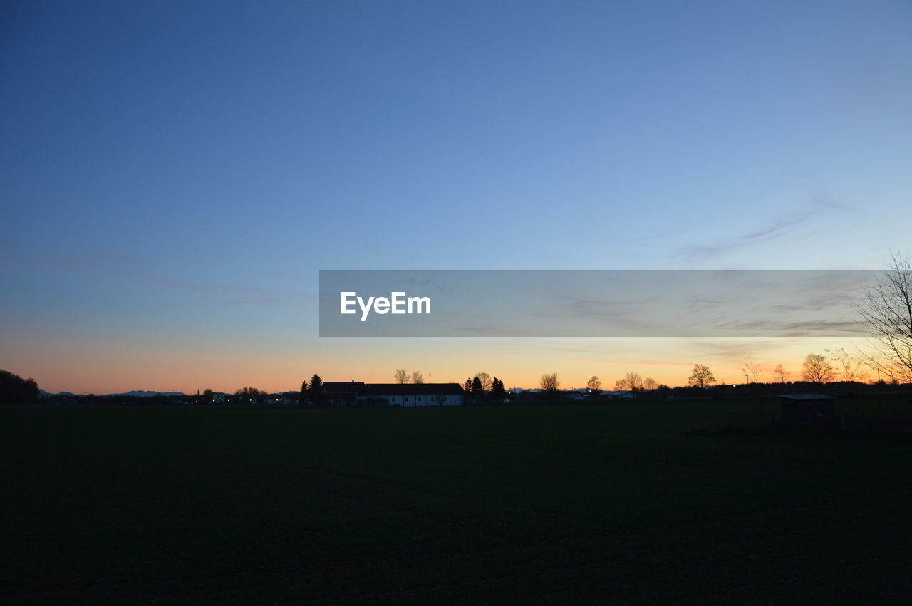 SILHOUETTE LANDSCAPE AGAINST CLEAR SKY DURING SUNSET