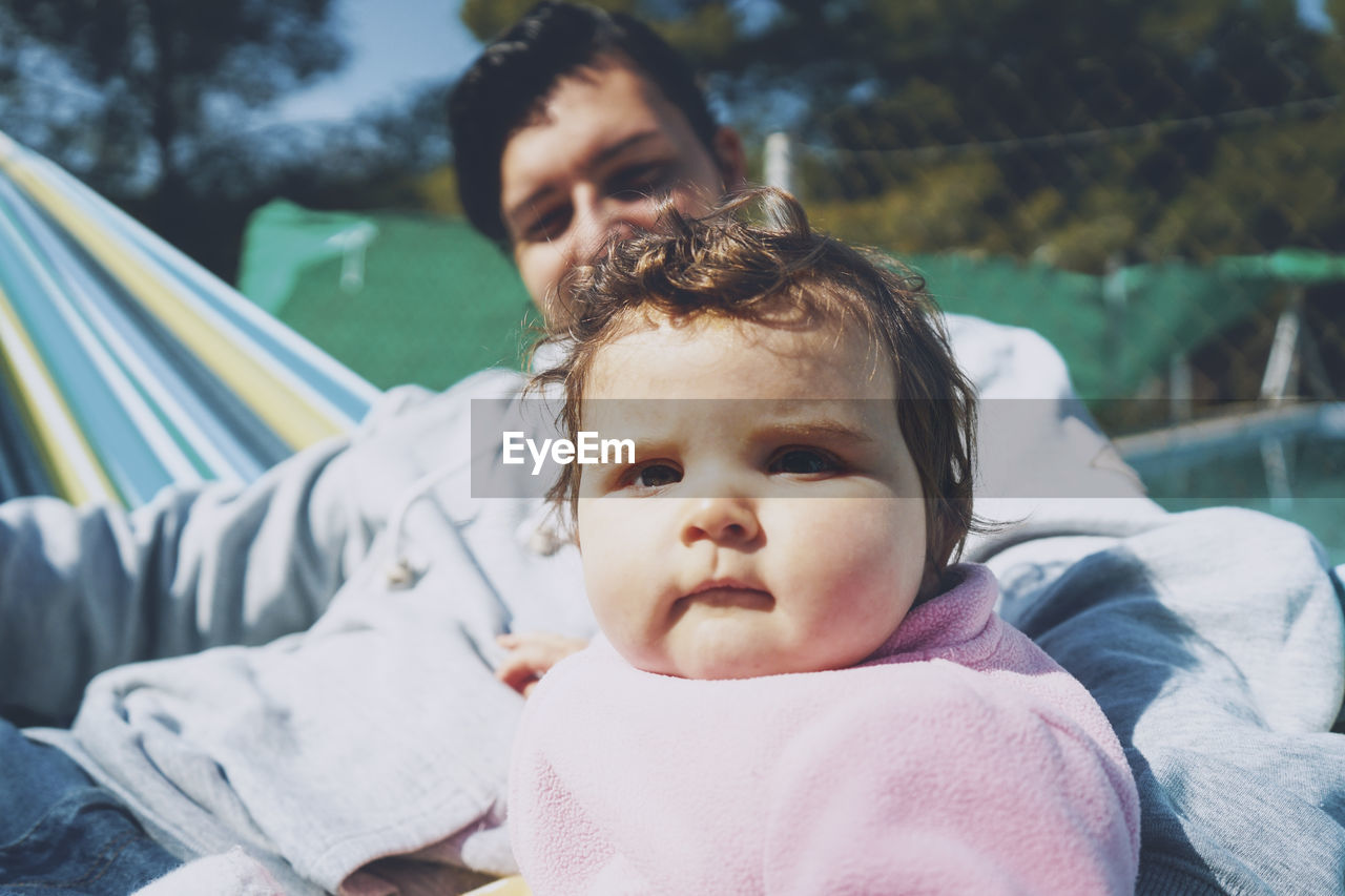 Portrait of mother cute baby with father outdoors