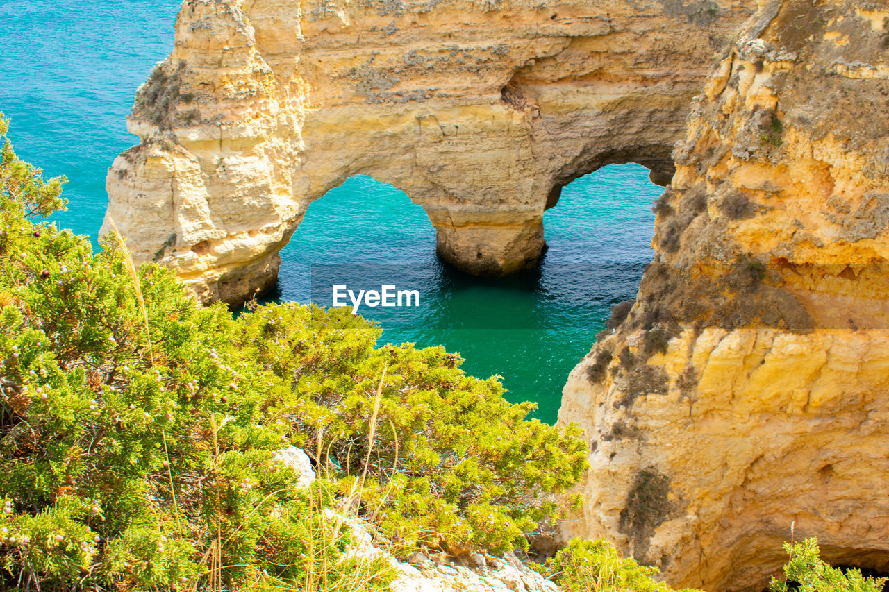 SCENIC VIEW OF ROCK FORMATION IN SEA