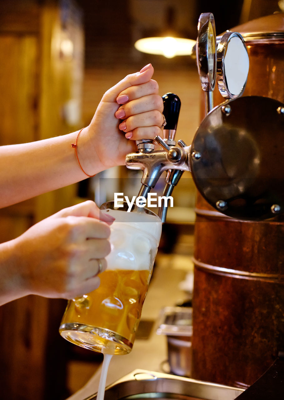 CLOSE-UP OF HAND POURING COFFEE