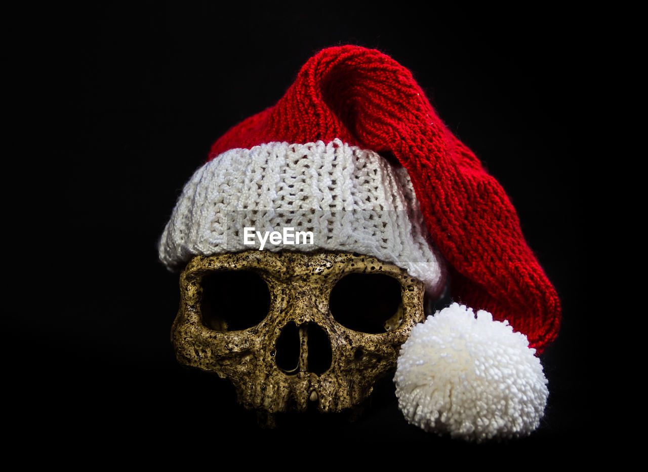 CLOSE-UP OF HAT IN BLACK BACKGROUND