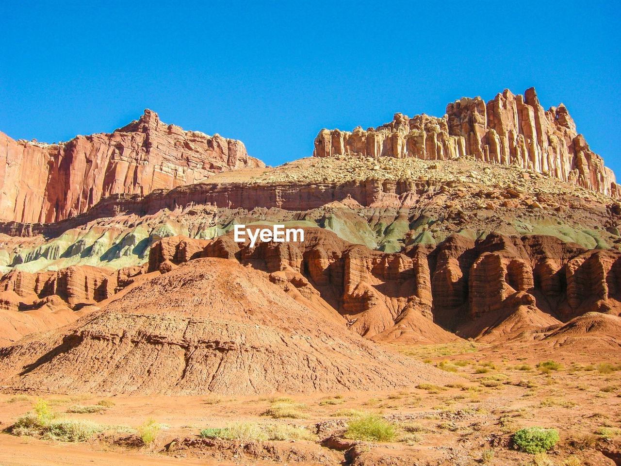 Low angle view of rock formations against clear blue sky at capitol reef national park