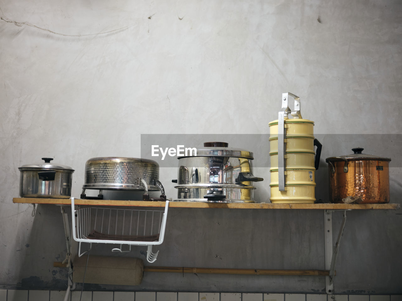 Old kitchen ware hanging on shelf. 