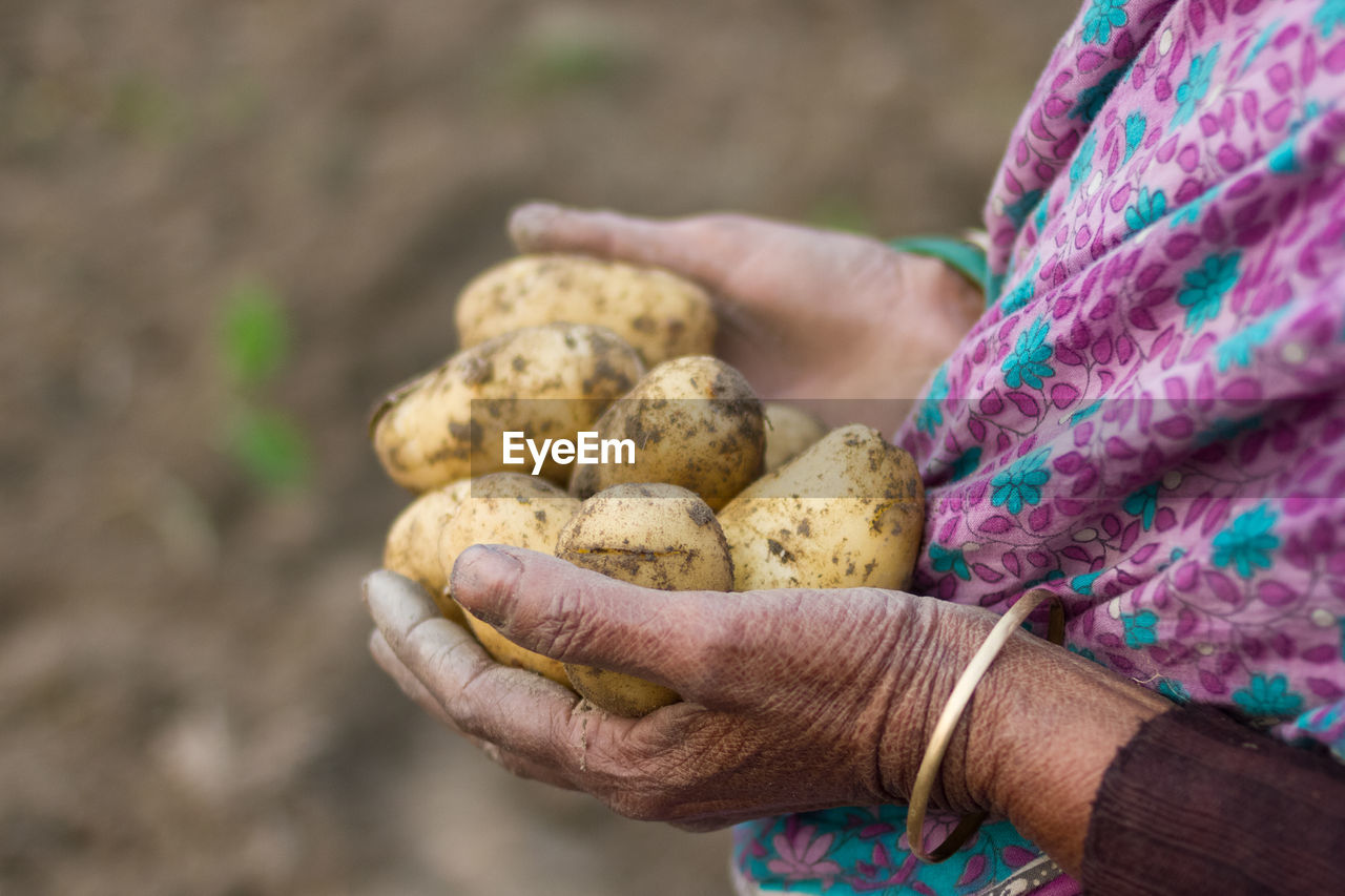 CLOSE-UP OF HAND HOLDING FOOD