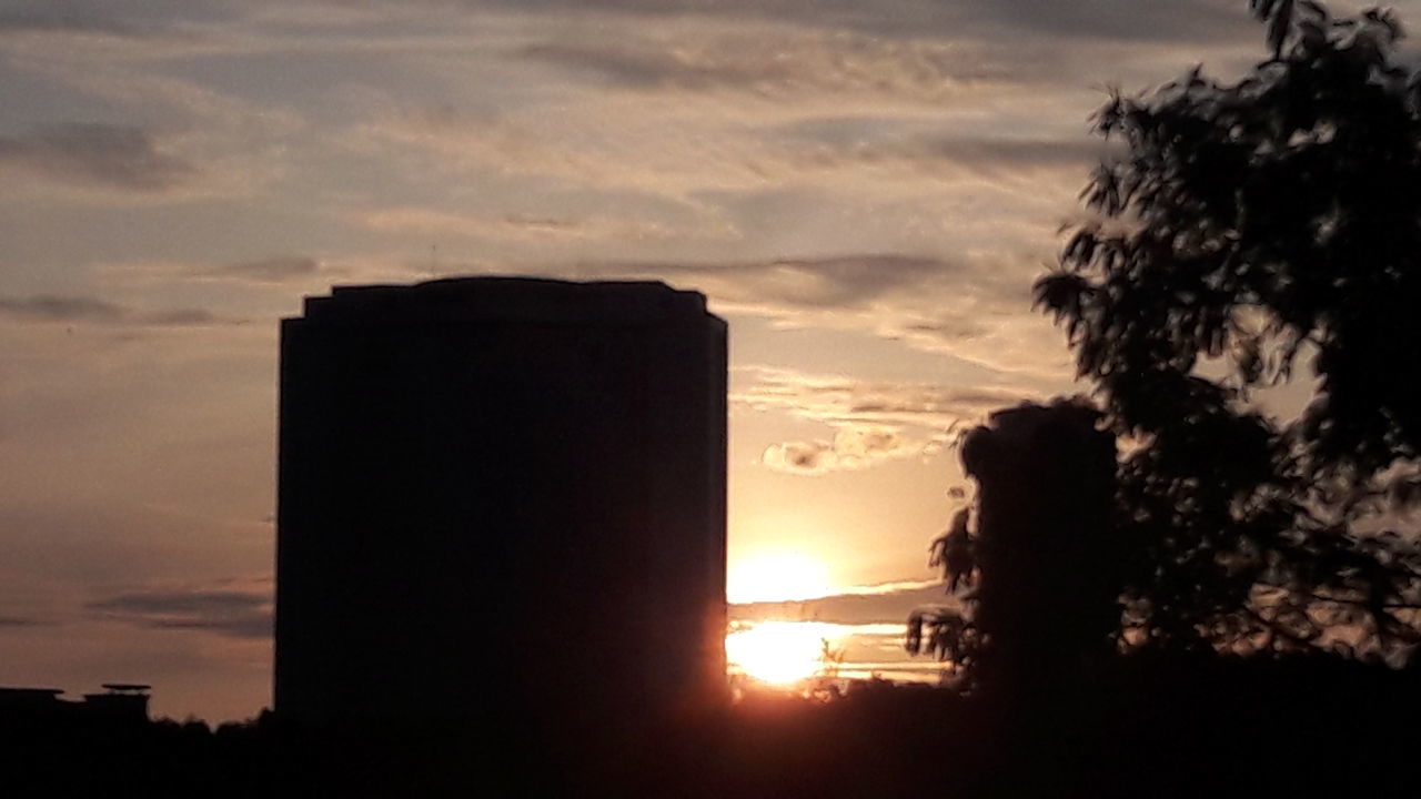 SILHOUETTE BUILDING AGAINST SUNSET SKY