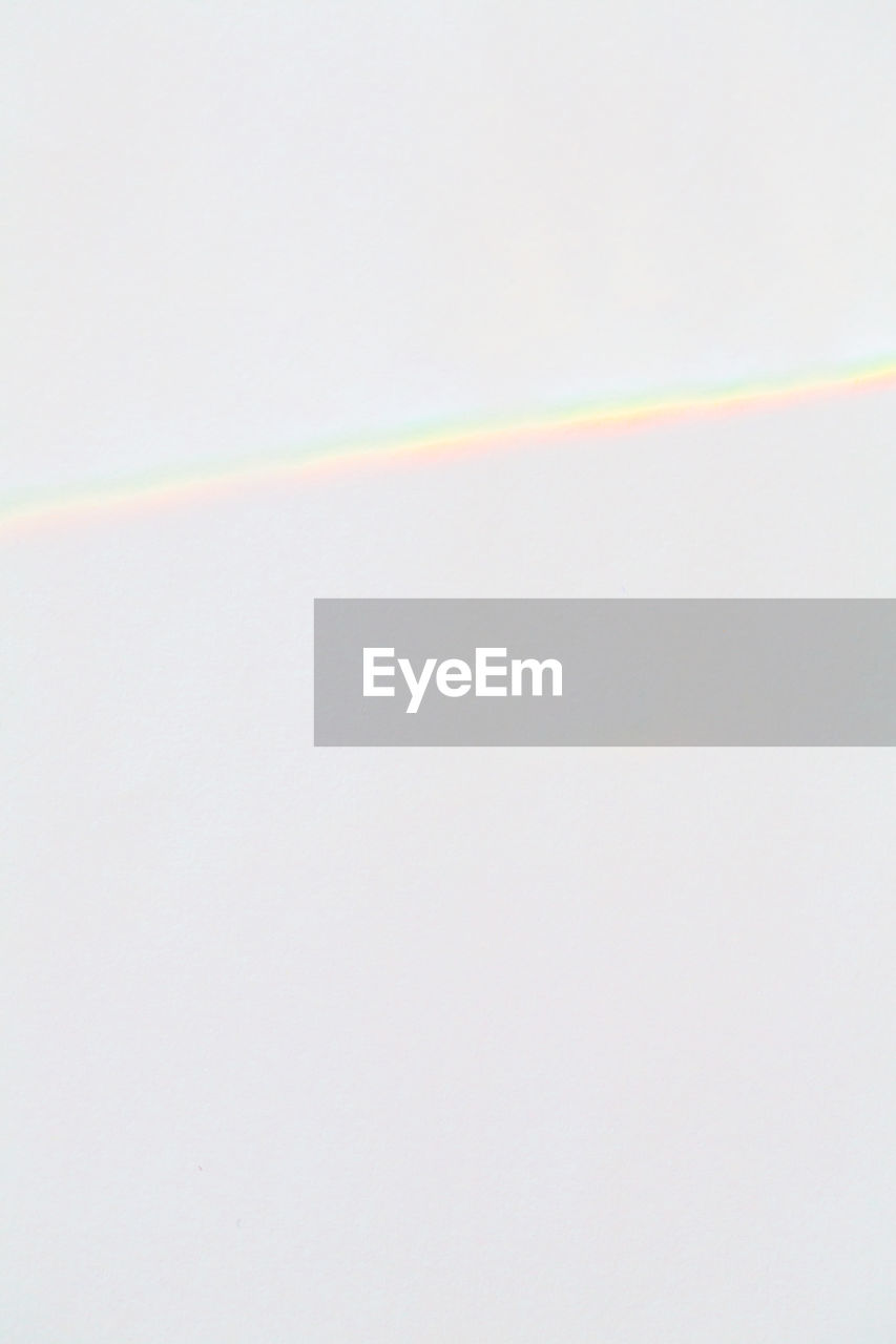Close-up of prism reflection against white background