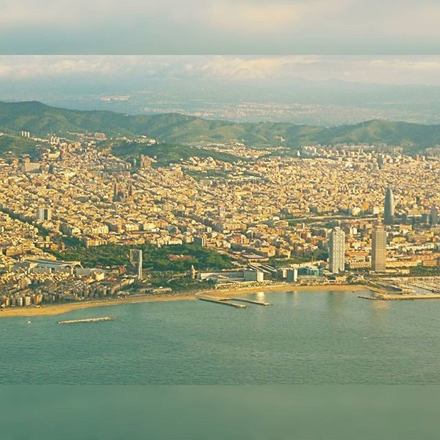 AERIAL VIEW OF CITYSCAPE WITH RIVER IN BACKGROUND