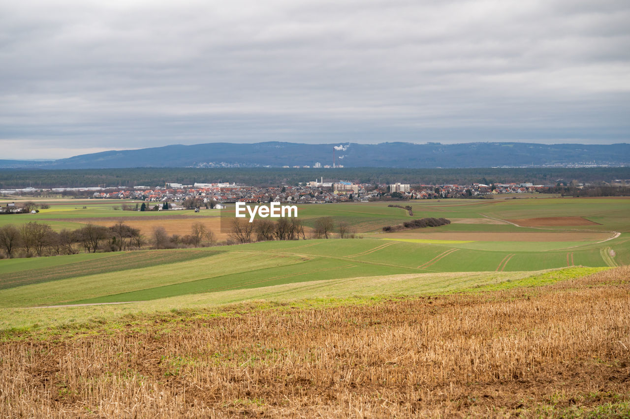 landscape, environment, land, plain, scenics - nature, sky, field, plant, nature, rural scene, rural area, agriculture, beauty in nature, cloud, tranquility, tranquil scene, grass, architecture, building, grassland, hill, no people, horizon, day, farm, building exterior, outdoors, built structure, green, tree, prairie, house, non-urban scene, idyllic, crop, growth, paddy field, village