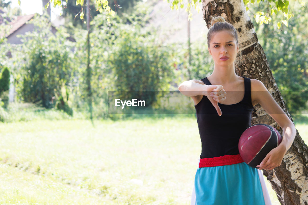 Portrait of angry basketball player holding ball